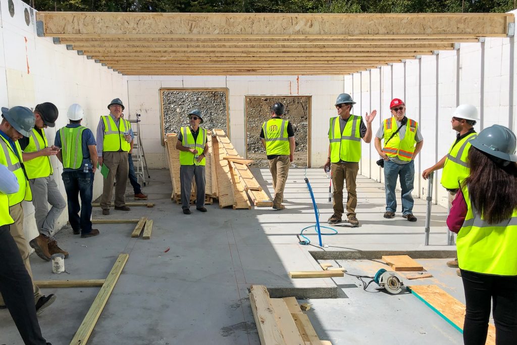 Construction team inside an Amvic™ ICF townhome at Boulder Farms during first-storey installation and on-site crew training.